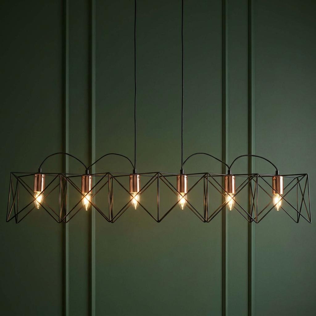 Anthea 6-light black geometric cage pendant with copper accents against a dark green paneled wall.