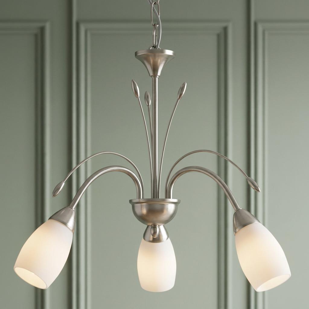 Antwerp 3-light antique chrome chandelier with frosted glass shades against a pale green paneled wall.