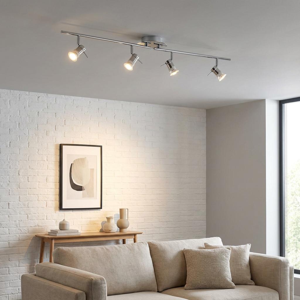 Aries polished chrome 4-light adjustable ceiling spotlights illuminating a modern living room.
