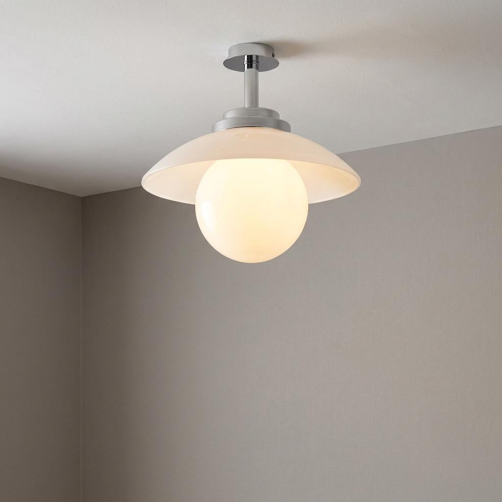 Art Deco globe ceiling light with a wide white shade and chrome hardware on a white ceiling.