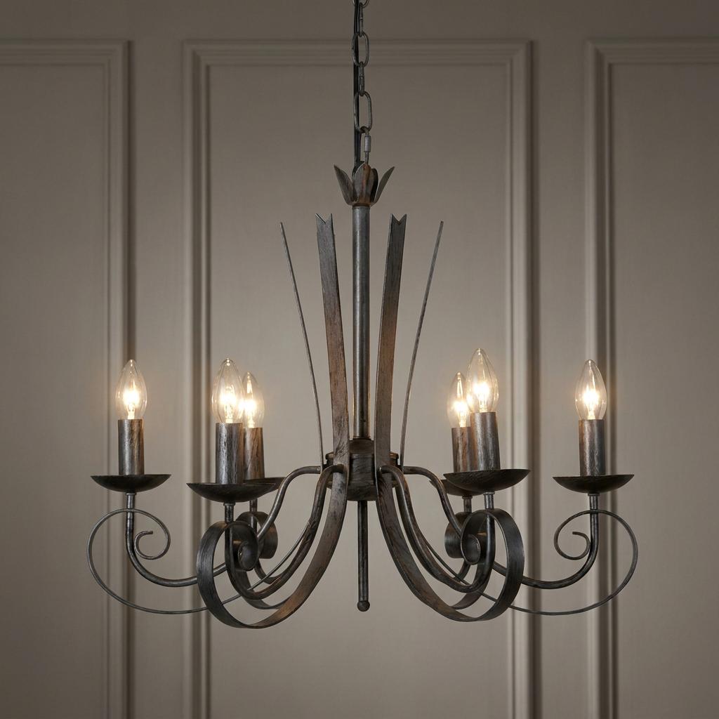 Arundel 6 light silver brushed black chandelier with scrolled arms and candle bulbs against a neutral paneled wall.