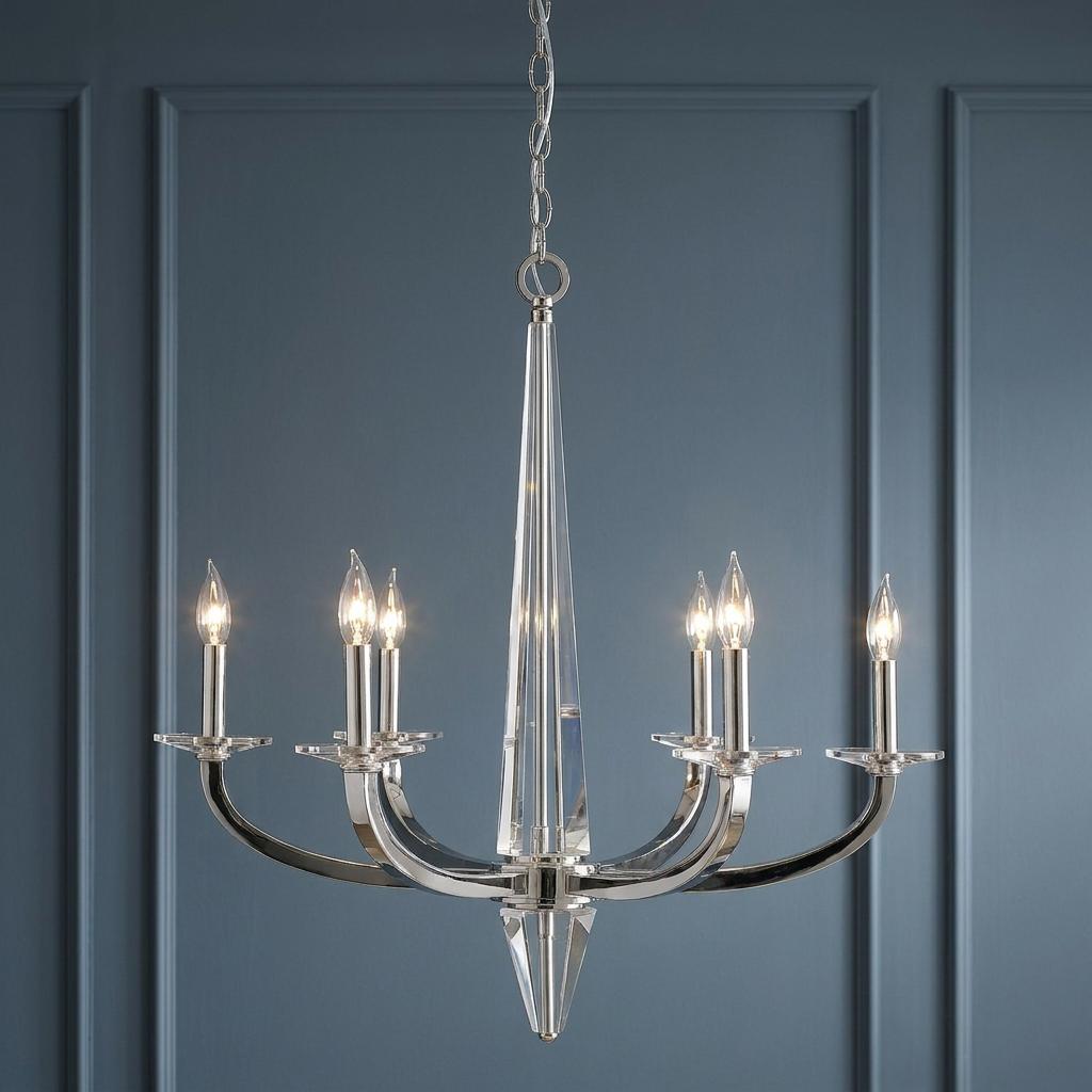 Ascher 6-light polished nickel chandelier with a glass spire and curved arms against a blue paneled wall.