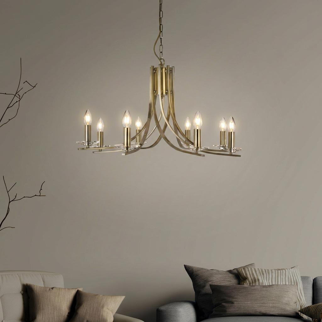 Antique brass 8-light chandelier with curved arms and glass sconces hanging in a neutral living room.