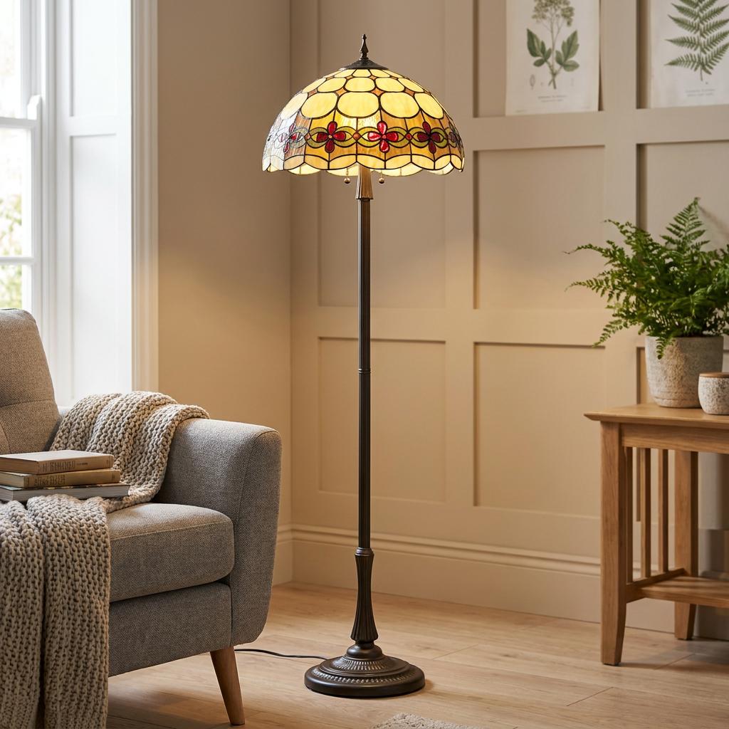 Atlantic Tiffany Floor Lamp with cream and red floral glass shade standing in a cosy living room.