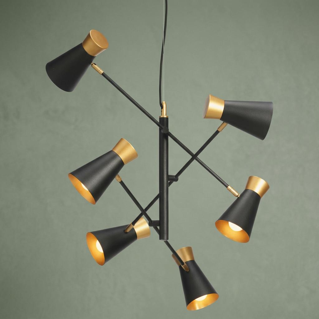 Bali 6-light ceiling light with adjustable black and gold conical shades against a sage green background.