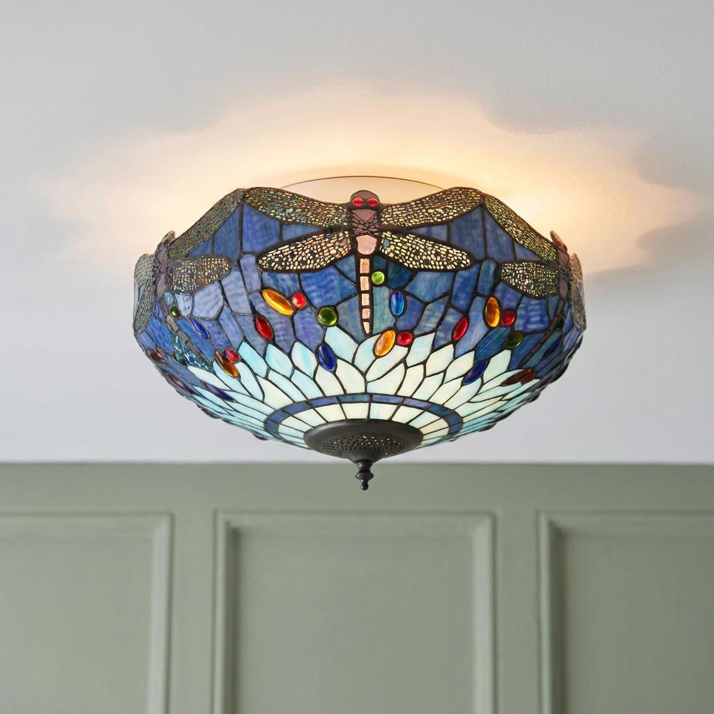 Blue Dragonfly Tiffany flush ceiling light with intricate stained glass mounted on a white ceiling above green walls.