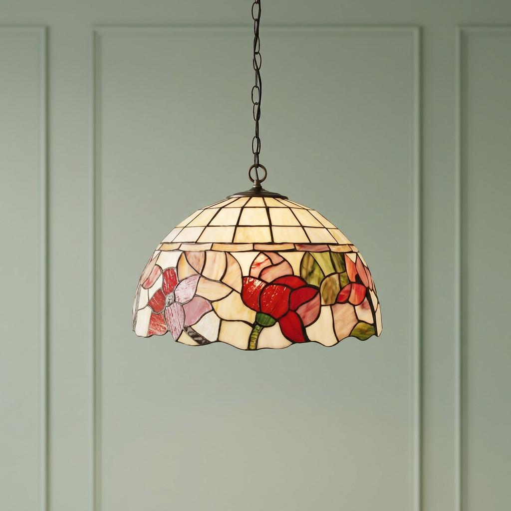 Tiffany-style floral stained glass pendant light hanging against a soft green paneled wall.