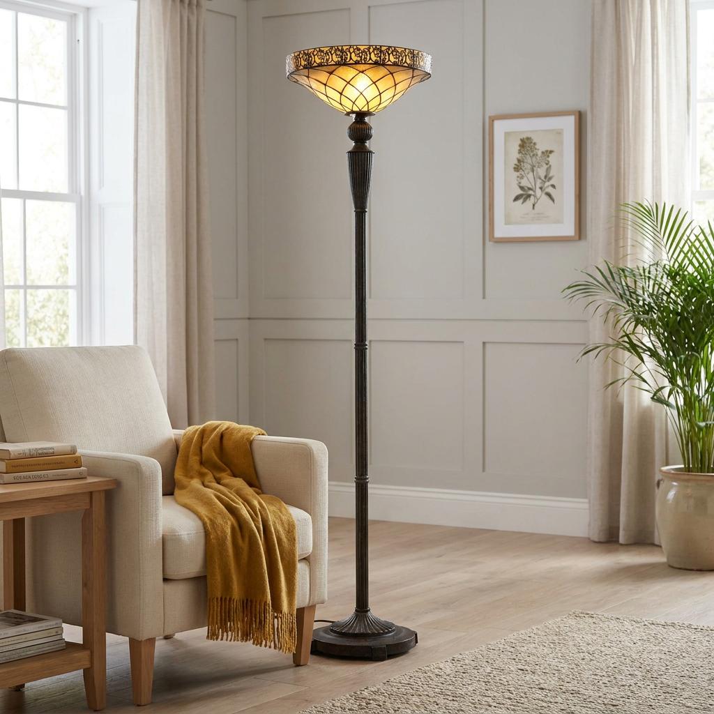 Cambridge Torchiere Tiffany Floor Lamp with a glowing lattice glass shade illuminates a cozy, neutral living room corner.