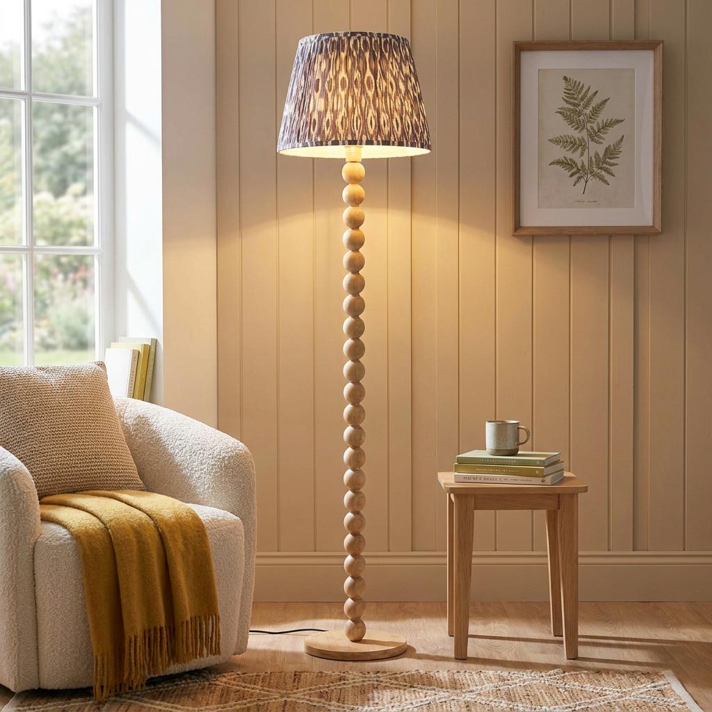 Cane Bamboo floor lamp with a beaded base and a grey Ikat pattern shade in a cozy living room setting.