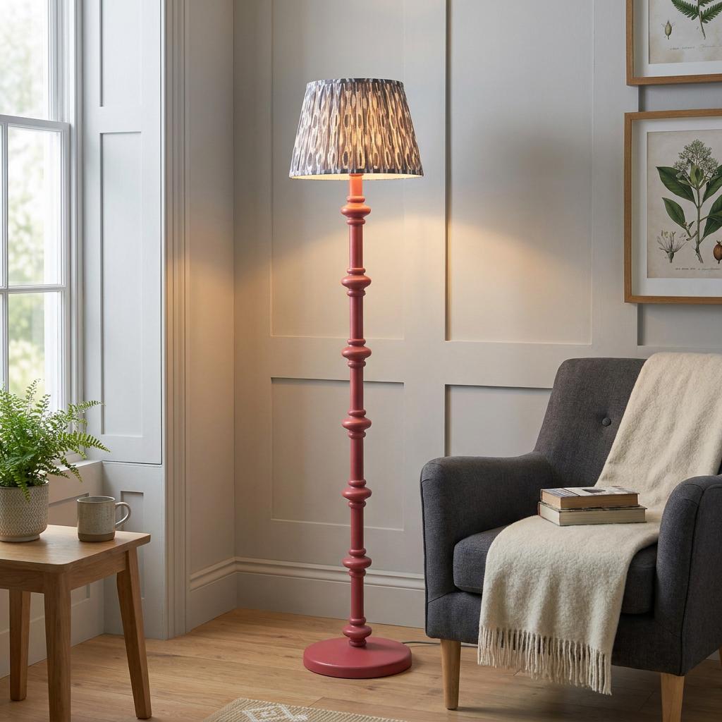 Carnaby pink floor lamp with an ikat pearl grey shade in a cozy living room corner by a grey armchair.