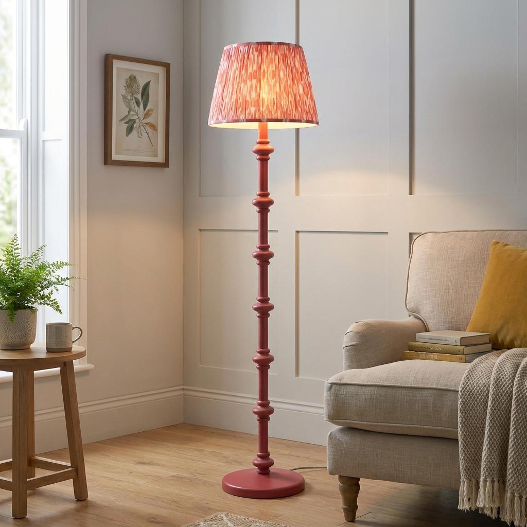 Carnaby pink wooden floor lamp with a coral ikat shade in a living room beside a neutral armchair.