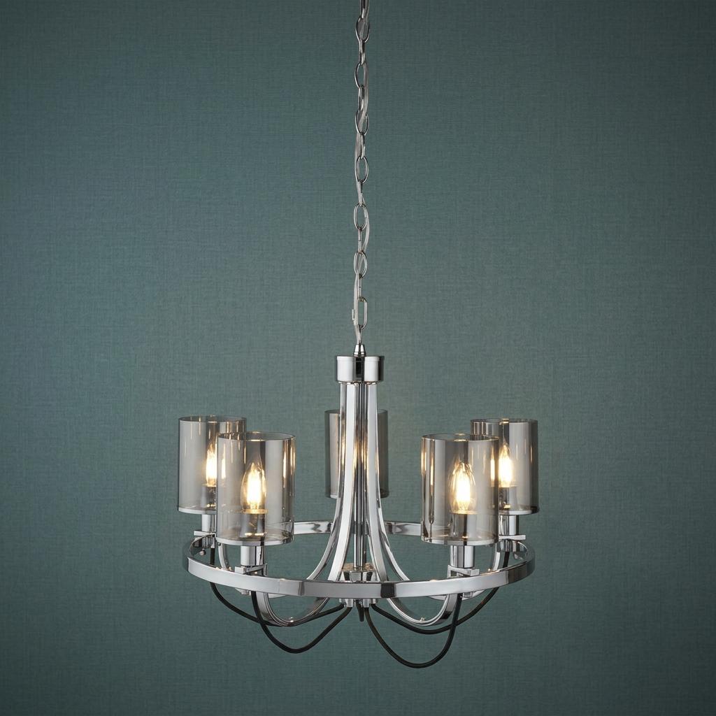 Modern five-light chrome pendant with cylindrical smoked glass shades against a teal textured background.