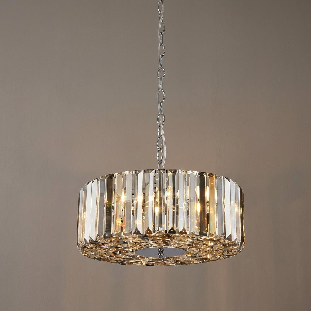 A cylindrical chrome pendant light with smoke and clear glass crystals hanging against a neutral background.