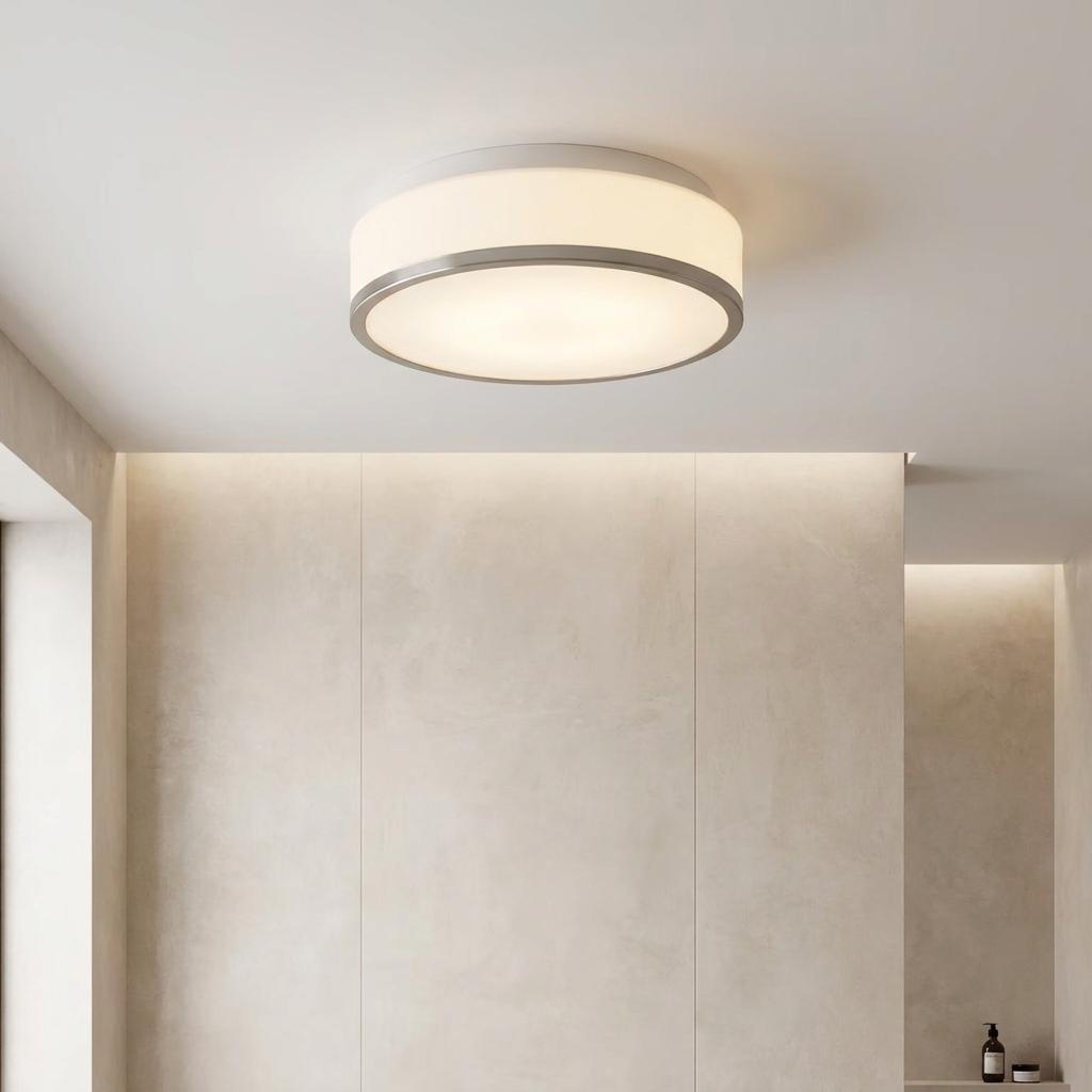 Illuminated Cheese flush bathroom ceiling light with opal glass and nickel trim on a neutral ceiling.