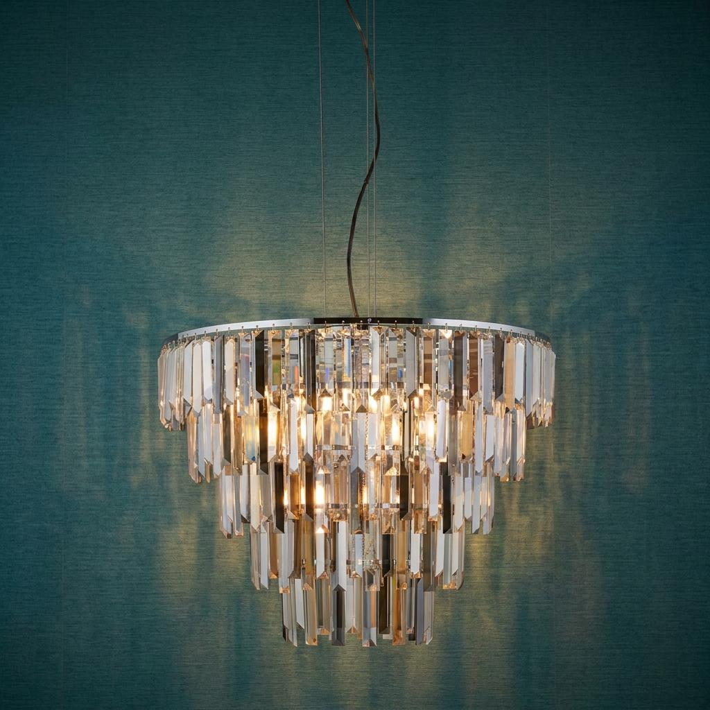 Clarissa 9-light chrome pendant with cascading crystal prism drops against a textured teal wall.