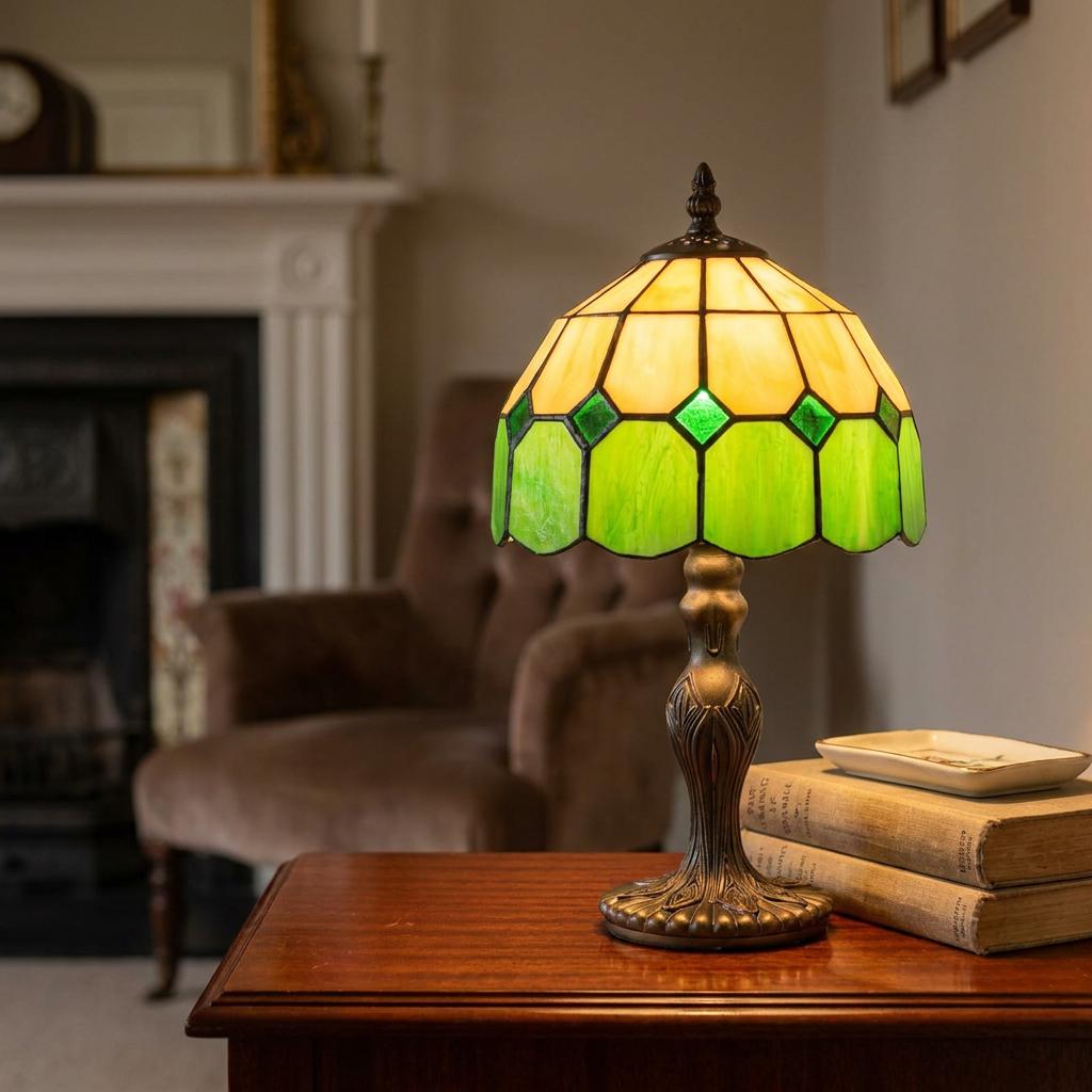 Ornate Tiffany bedside lamp with a yellow and green stained glass shade on a wooden table in a traditional room.