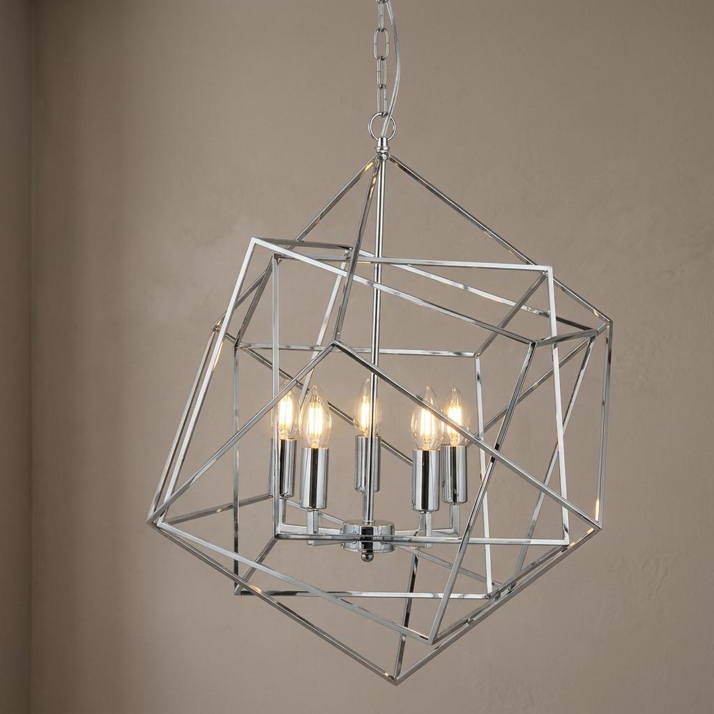 Modern chrome geometric cube pendant light with five lit bulbs against a neutral wall.