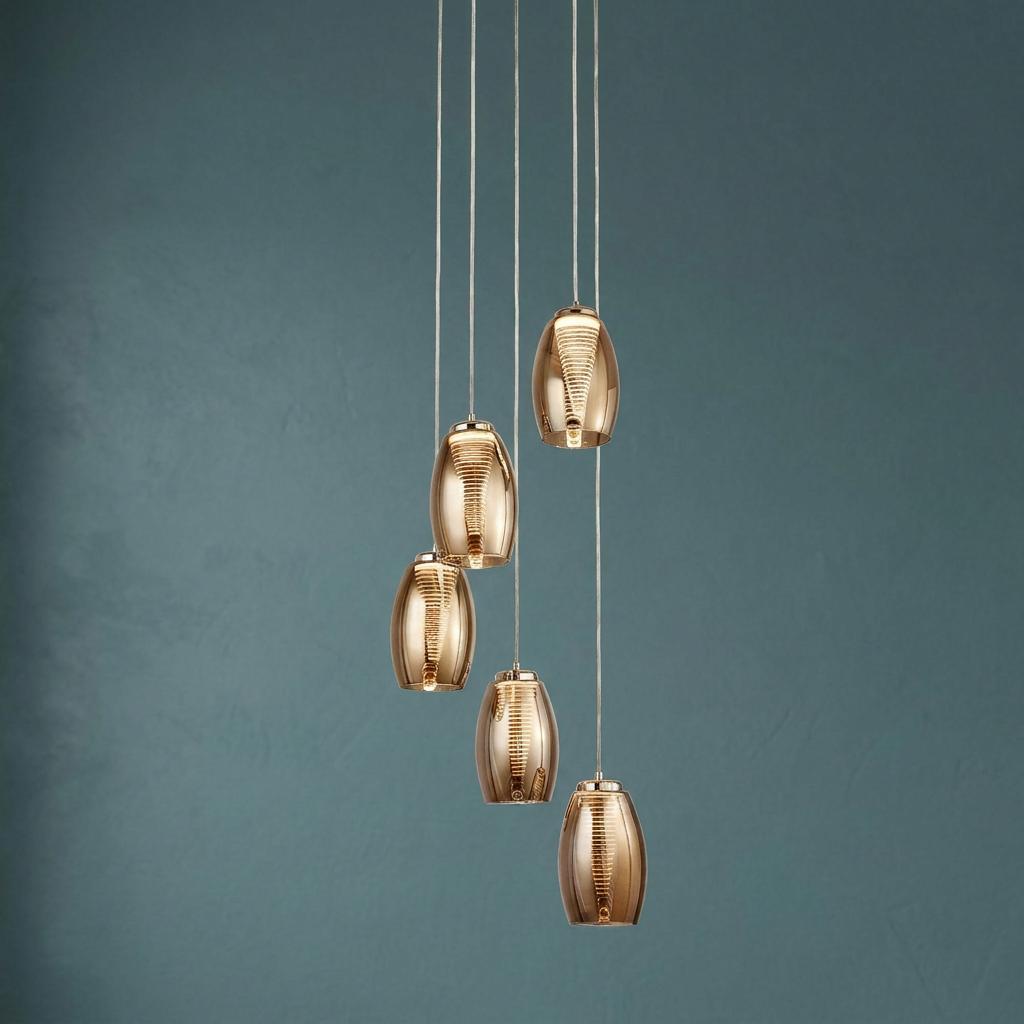 Cyclone 5-light LED multi-drop pendant with spiraled amber smoked glass shades hanging against a teal wall.