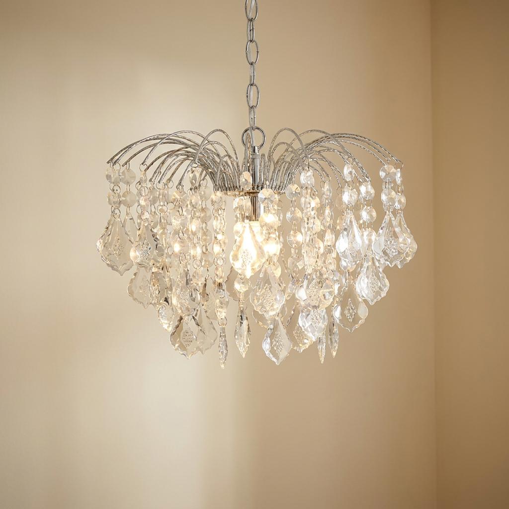 Chrome and crystal chandelier-style pendant lamp shade with cascading droplets against a neutral wall.