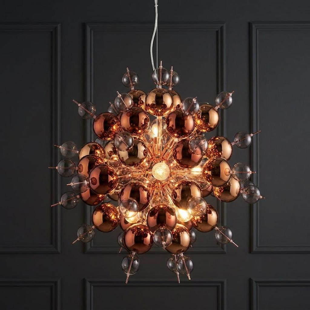 Dreamscape 9 light copper pendant with tinted glass spheres hanging against a dark grey panelled wall.