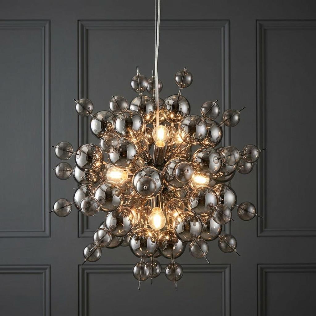 Dreamscape pendant light with black chrome finish and tinted glass spheres, illuminated against a grey wall.