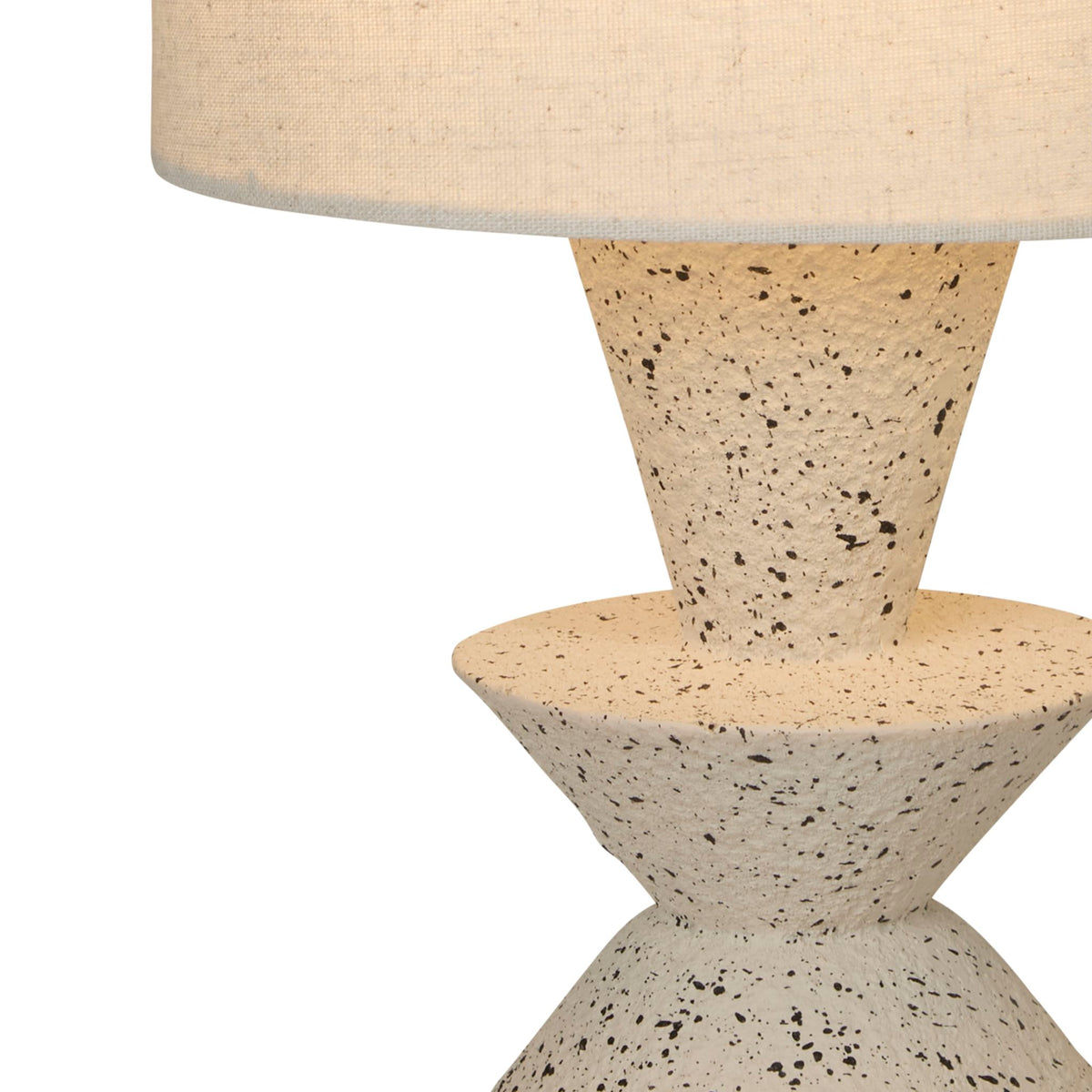Detail of the Malacca lamp's speckled terrazzo cones beneath a woven beige linen shade