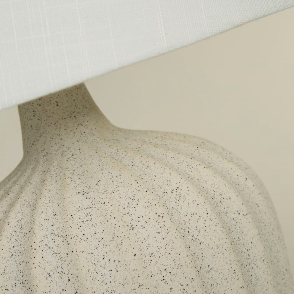 Close-up of the Padstow lamp speckled terrazzo ribs beneath the white fabric shade