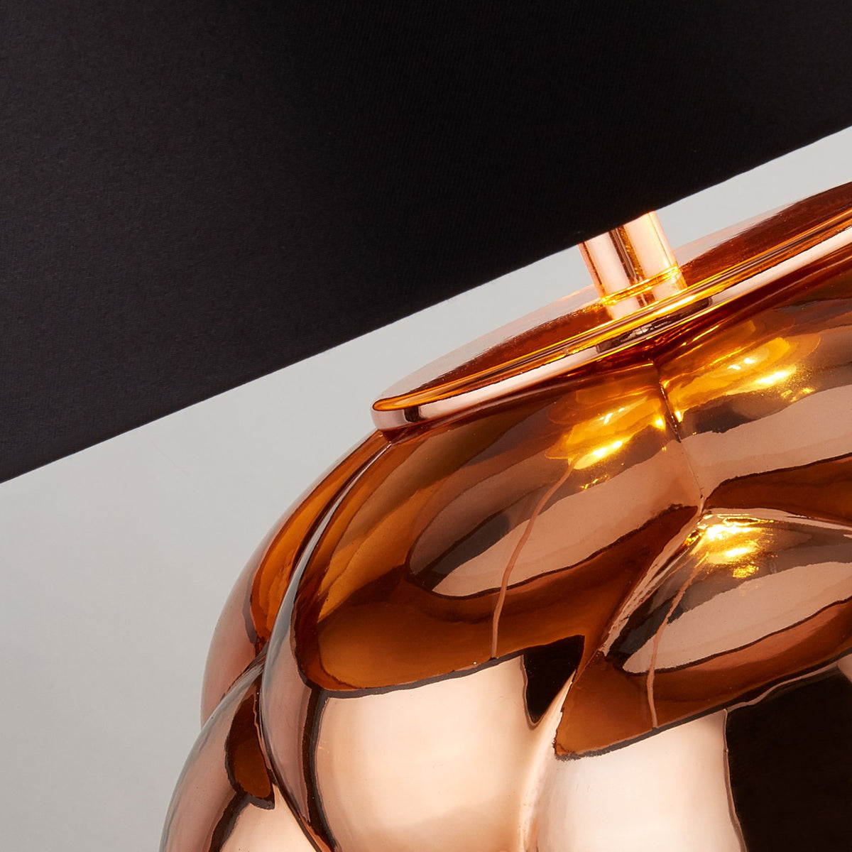 Close-up of the Fizz lamp's bubbled copper glass base and glowing lampholder
