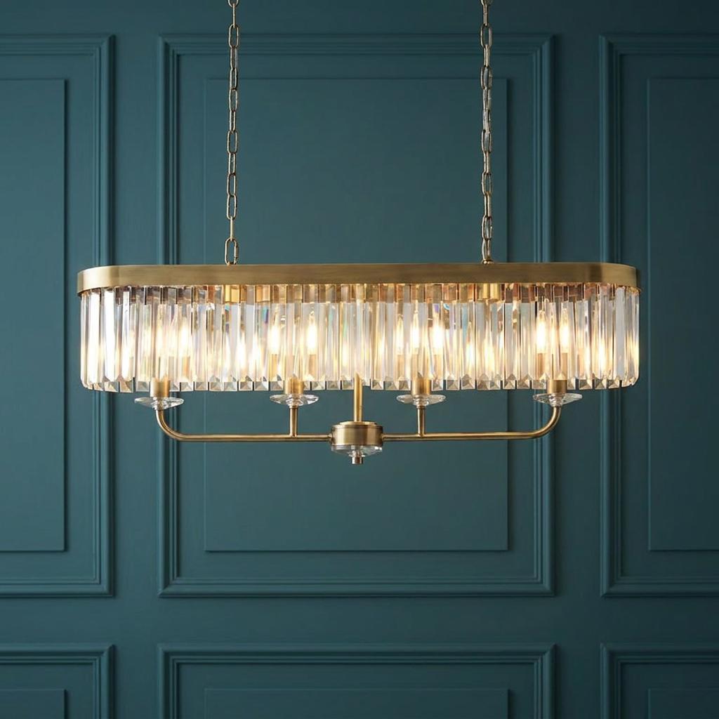 Linear brass ceiling pendant with faceted glass rods against a teal panelled wall.