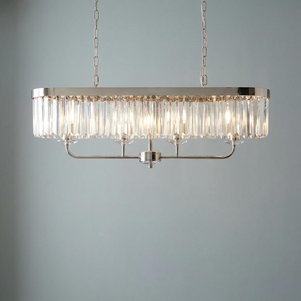 Ealing nickel 4-light linear ceiling pendant with cut faceted glass prisms hanging against a pale blue wall.