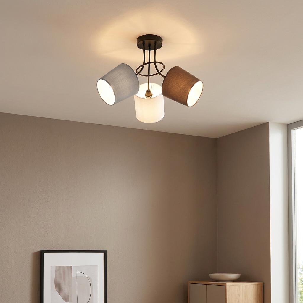 Three-light semi-flush ceiling fixture with grey, white, and brown fabric shades in a contemporary living space.