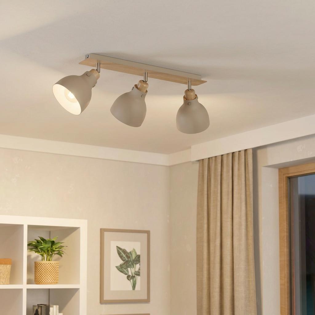 Modern Eglo Arrecife three-light bar spotlight with sand-colored shades and wooden accents on a white ceiling.