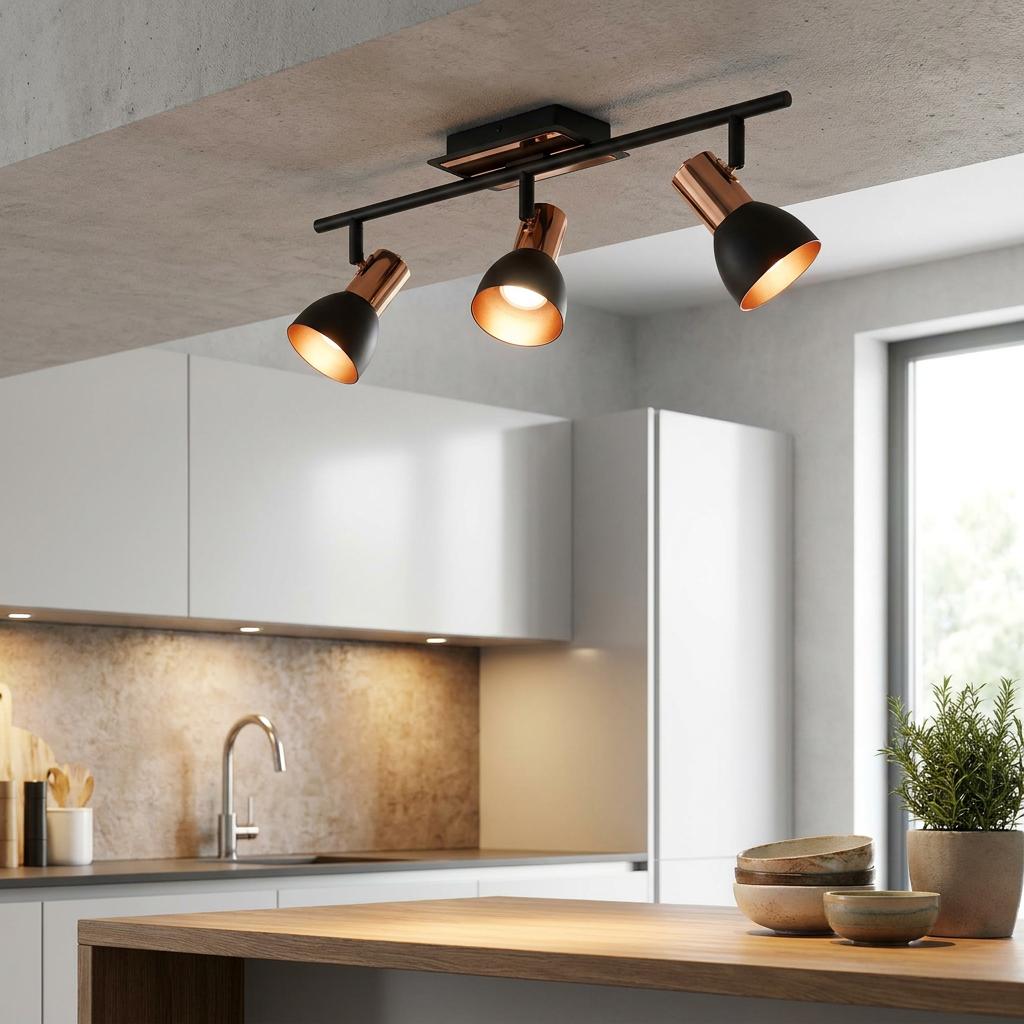 Eglo Barnham 3-light copper and black bar spotlight mounted on a concrete kitchen ceiling above a wooden island.