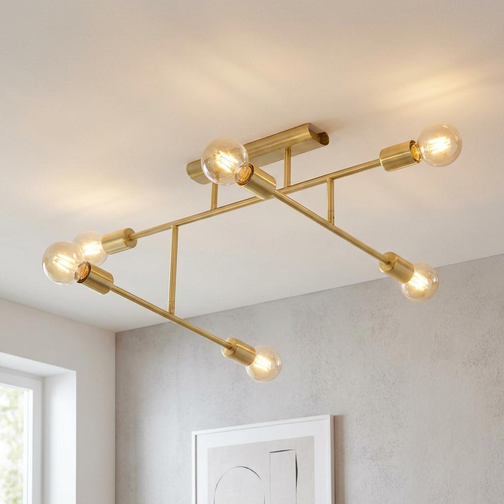 Modern 6-light brass semi-flush ceiling fixture with lit globe bulbs on a white ceiling.