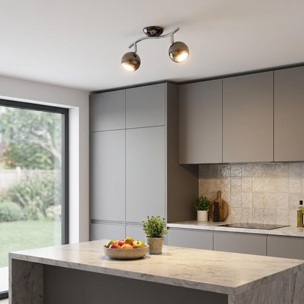 Eglo Bimeda two-light black nickel and chrome spotlight illuminates a modern grey kitchen with a marble island.