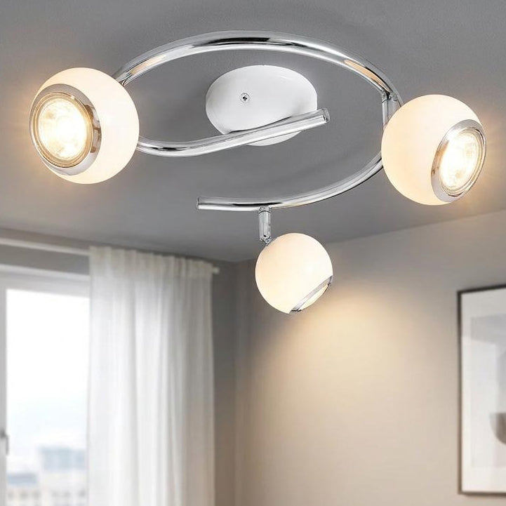 Eglo Bimeda 3 Light White & Chrome Spotlight mounted on a living room ceiling above a white sofa.