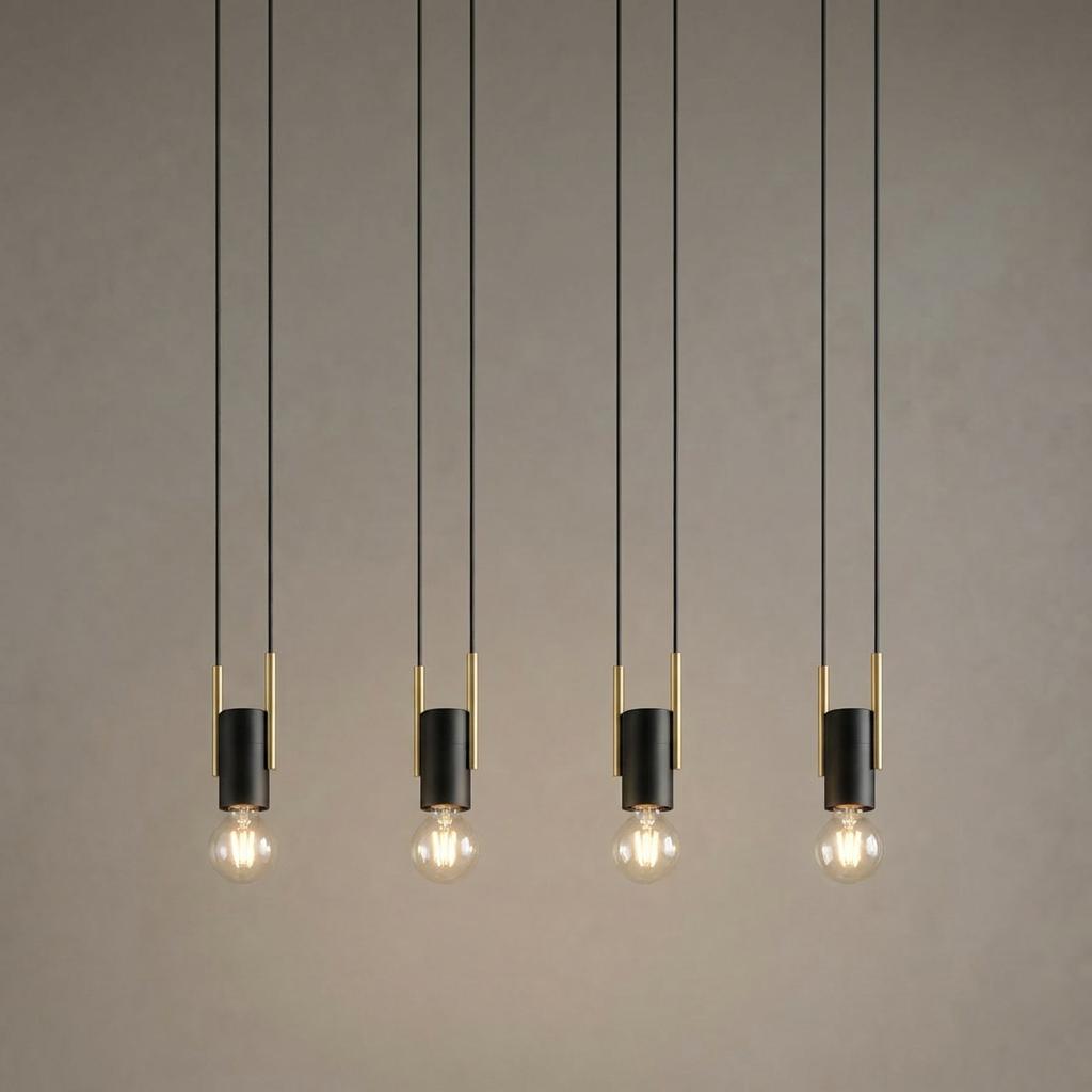 Four minimalist black and brass pendant lights with exposed bulbs hanging against a textured wall.