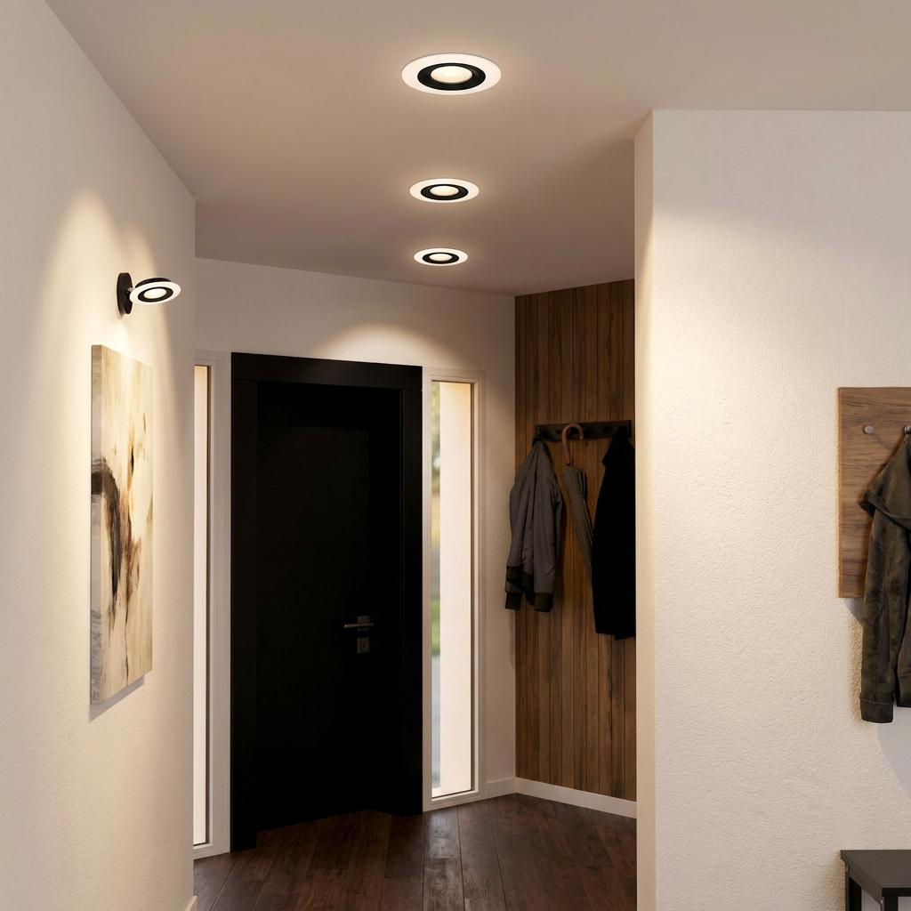 Three black and white LED recessed spot lights illuminating a modern hallway interior.