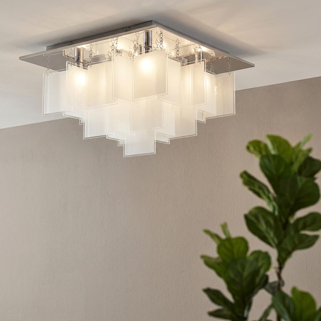 Modern chrome flush ceiling light with tiered white frosted glass panels, lit in a contemporary interior.