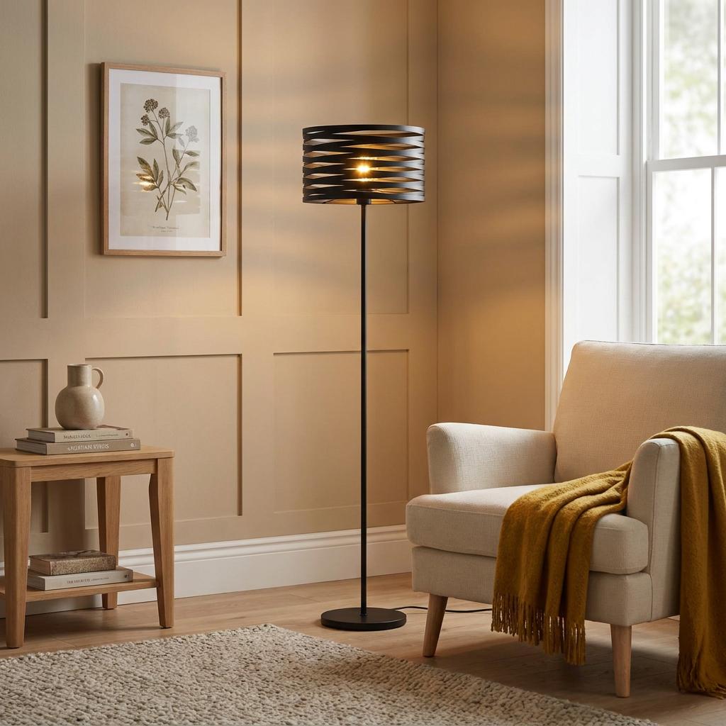 Eglo Cremella black steel floor lamp with a spiral shade illuminates a cozy living room next to an armchair.