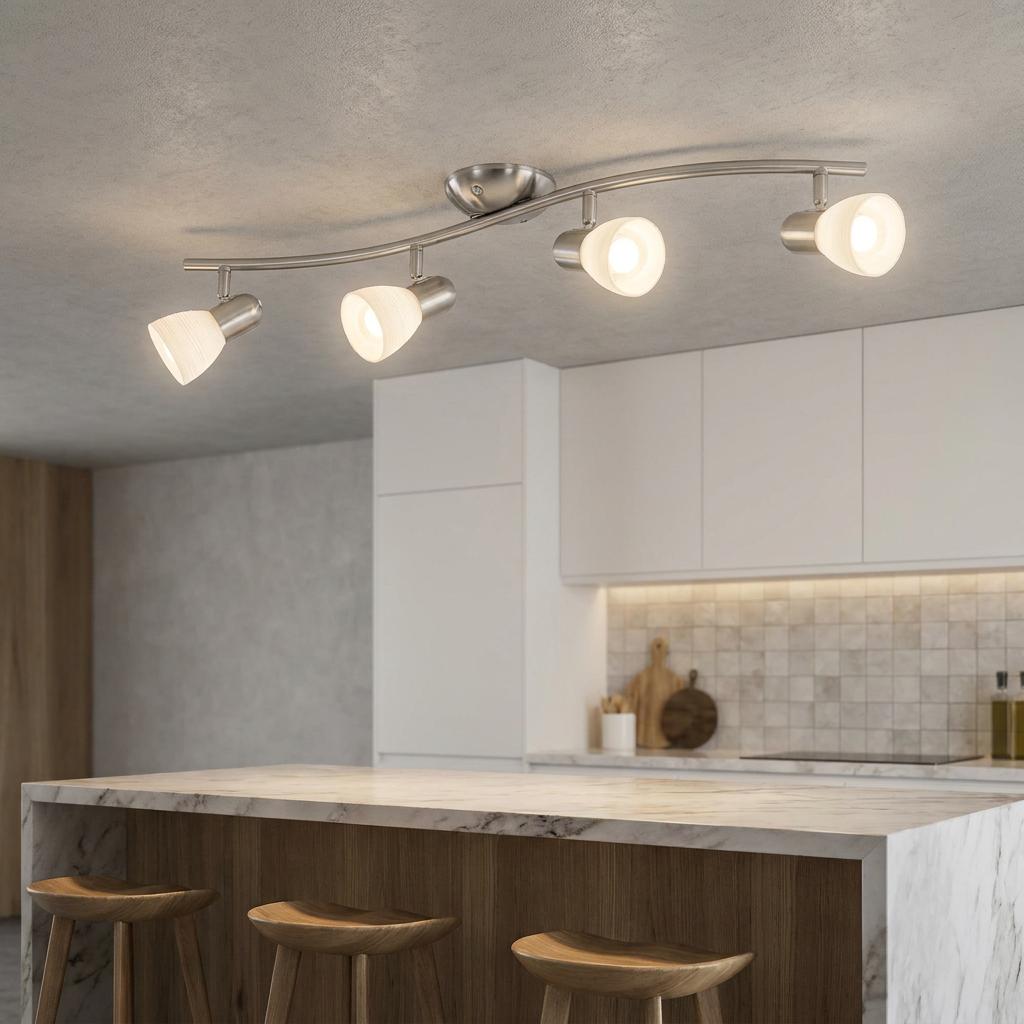 Four-light nickel bar spotlight with white glass shades on a ceiling in a modern kitchen.