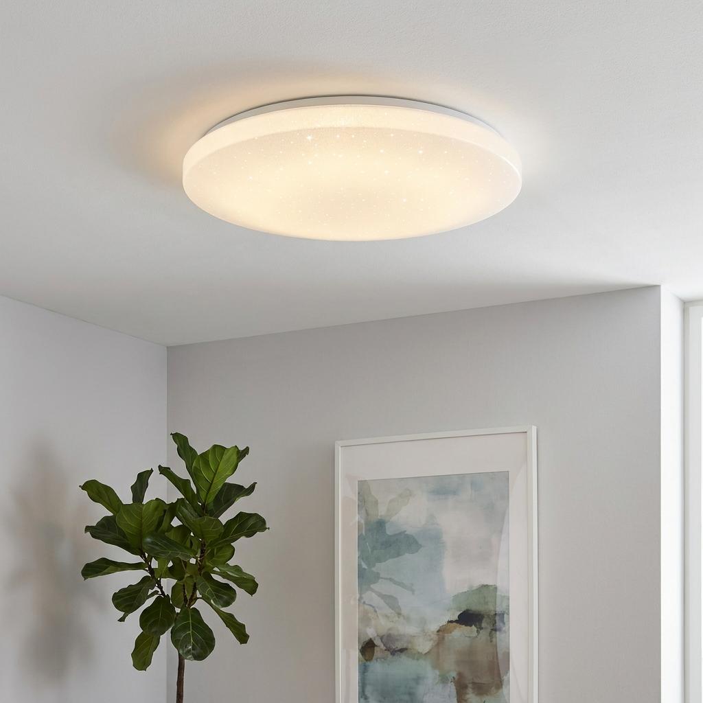 Eglo Frania-A round white LED flush ceiling light with a sparkling finish illuminated in a modern room.
