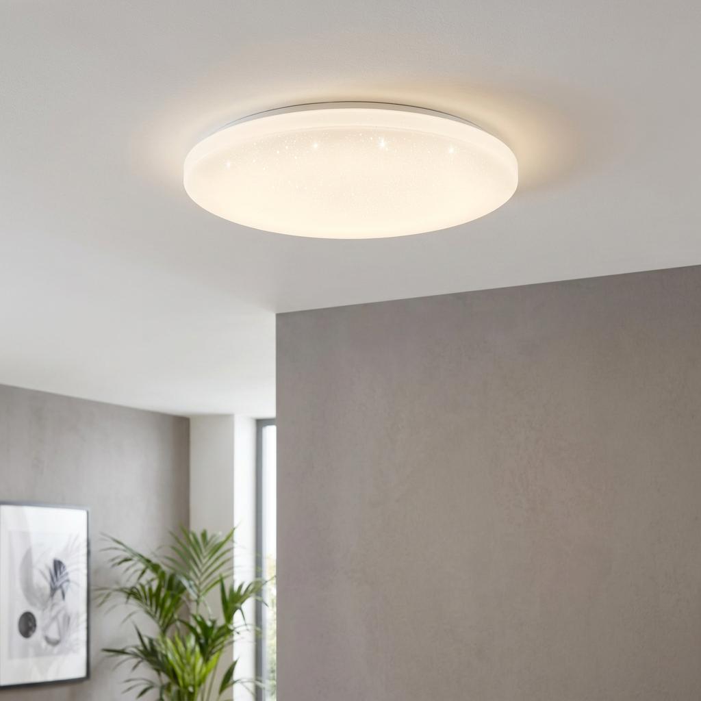 Round white LED flush ceiling light with a sparkling starry effect, mounted in a modern grey living room.