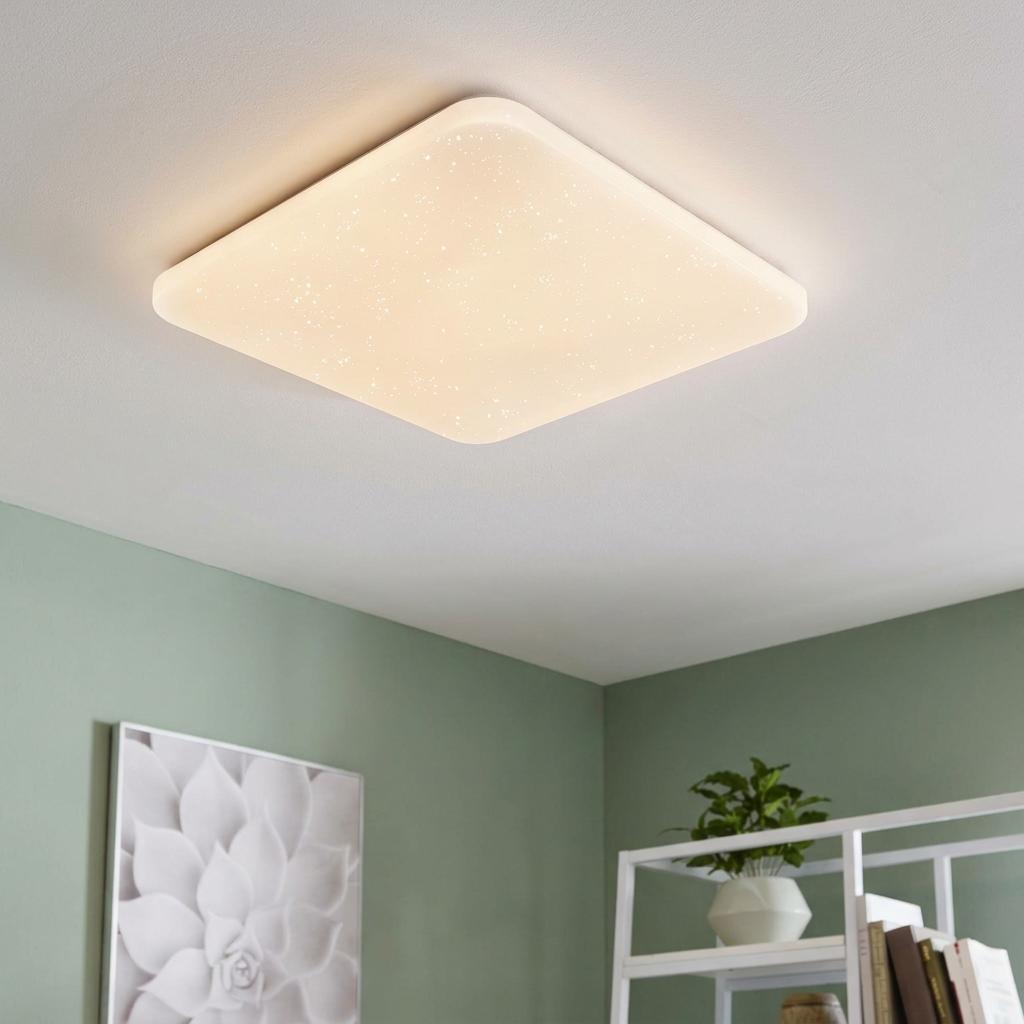 Square LED flush ceiling light with crystal starry effect mounted on a white ceiling in a modern living room.