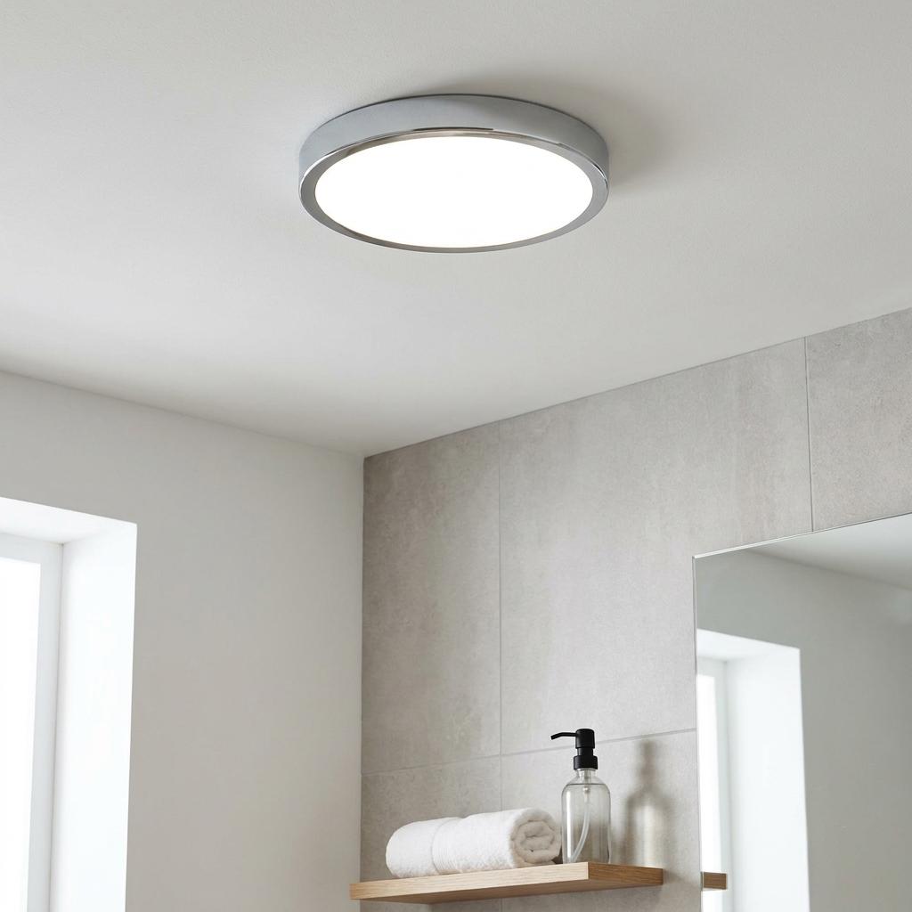 Round Eglo Fueva 5 chrome flush ceiling light illuminating a modern bathroom with grey tiles.