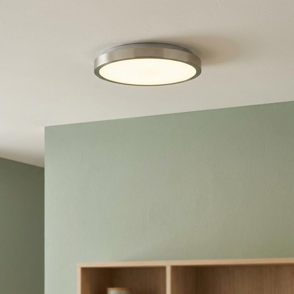 Eglo Fueva 5 circular LED flush ceiling light with a satin nickel finish illuminated on a white ceiling.