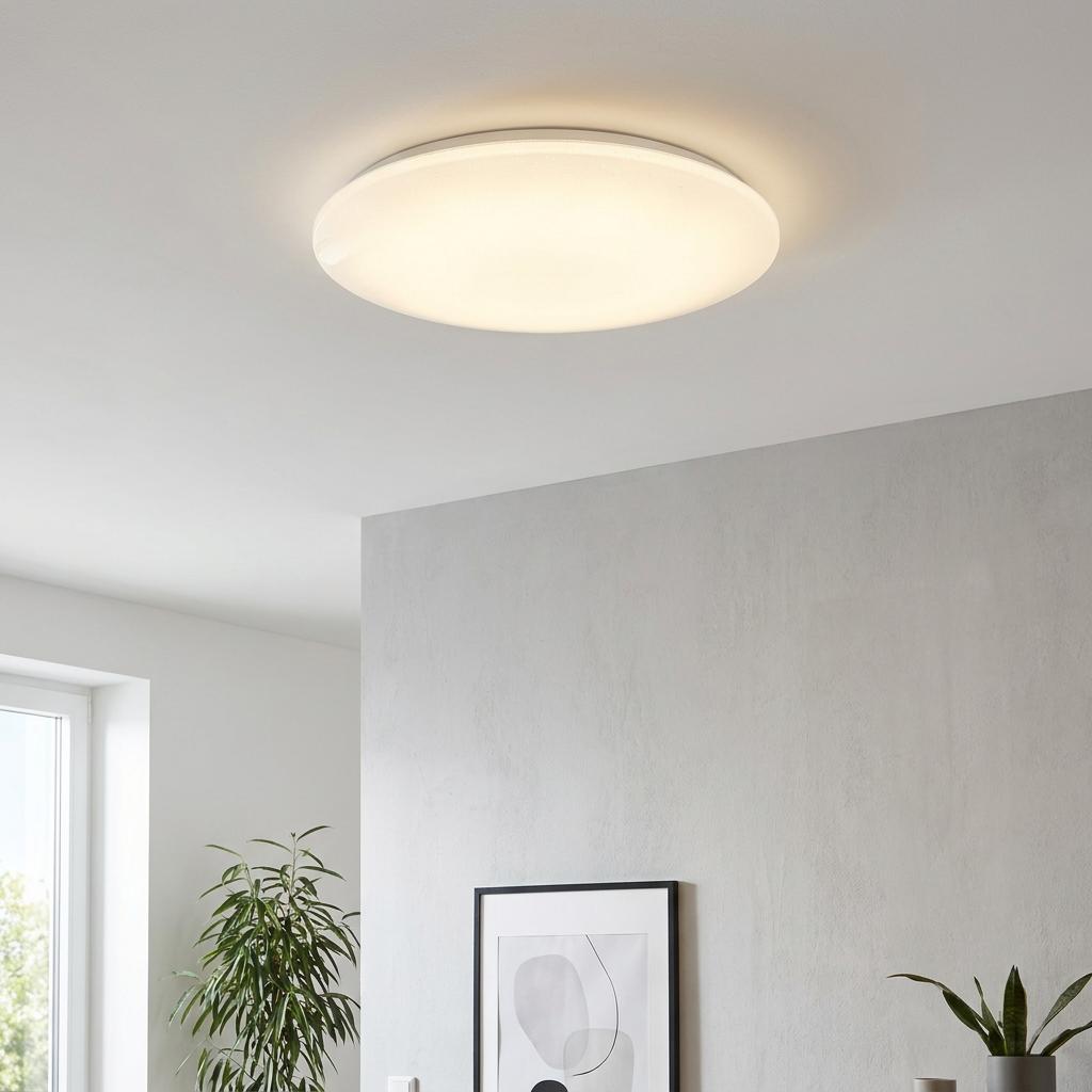 Large round Eglo Giron-S LED flush ceiling light glowing warmly in a modern interior setting.