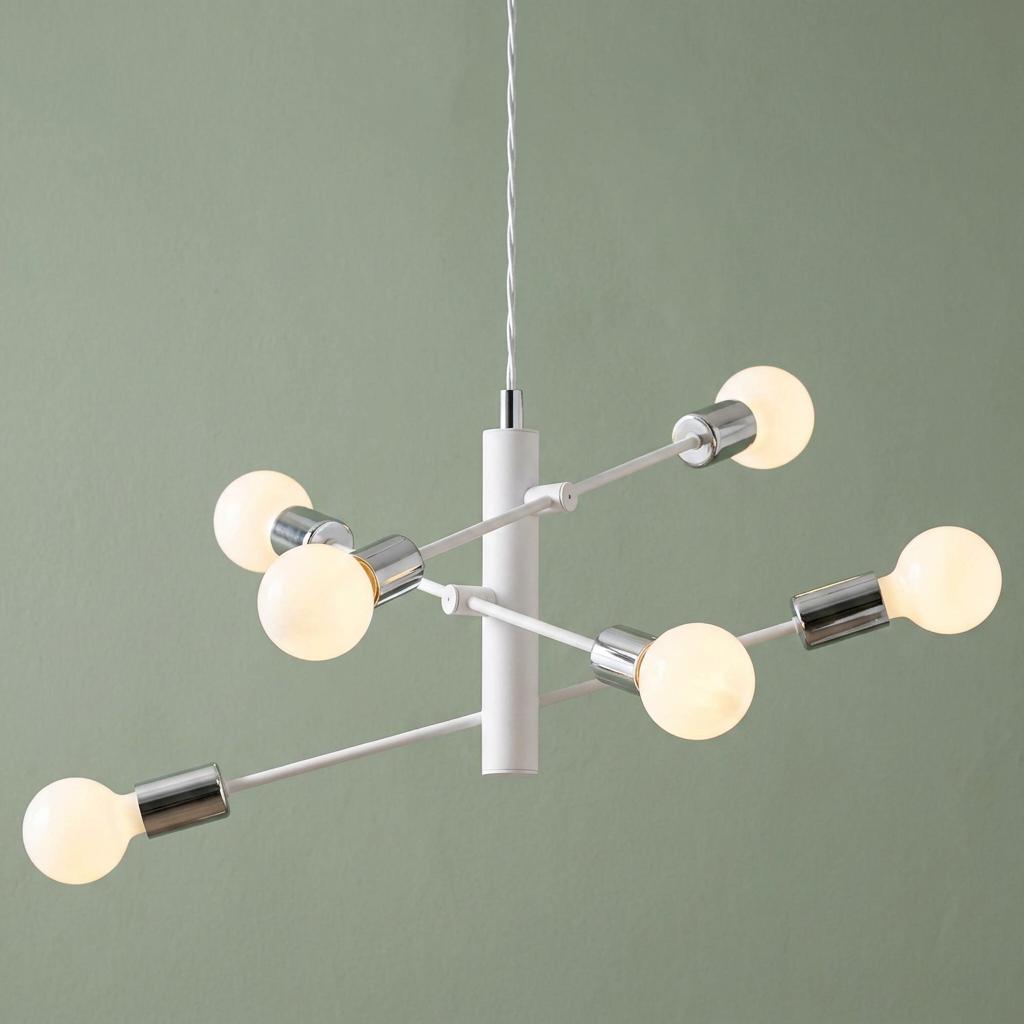 White and chrome 6-light modern pendant fixture with glowing orb bulbs against a sage green wall.