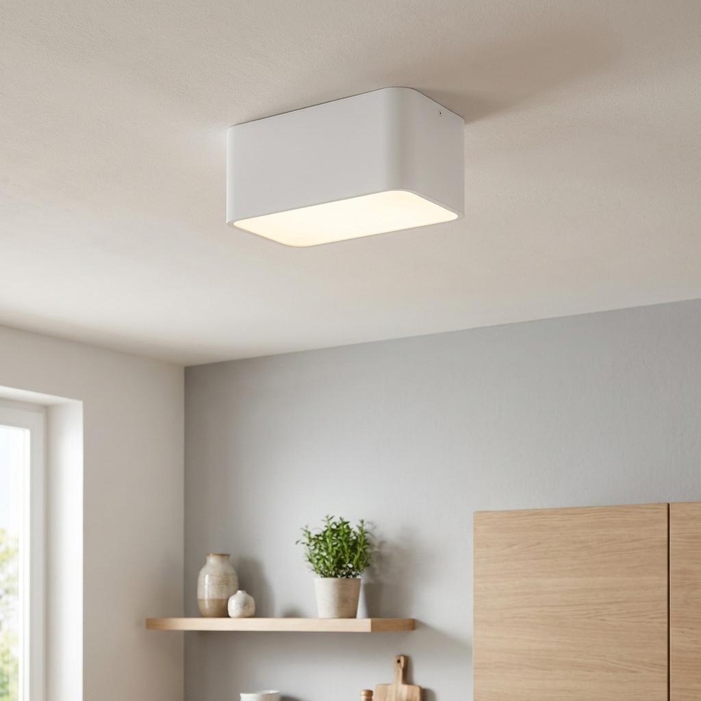 White rectangular flush ceiling light illuminated in a modern interior setting with grey walls and wooden furniture.