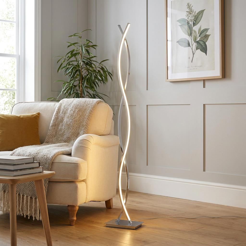 Modern chrome floor lamp with a wavy LED design standing next to an armchair in a stylish living room.